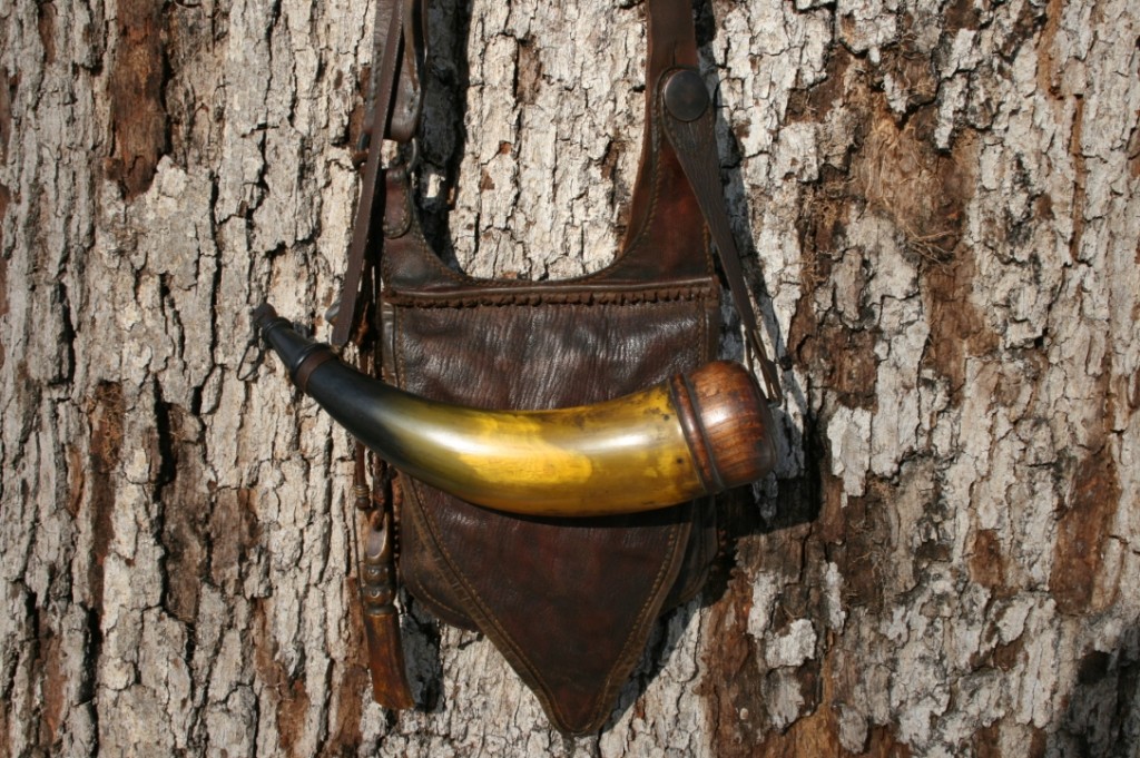 Jeff Bibb Southwest Virginian Pouch and HornThis is a classic SW-VA pouch (in lined goatskin), along with a matching horn. The horn is about 12 - 12.5" around the curve, and about 2.5" wide at the base. Also very translucent at the back, so he can see the powder pretty well in the light.  The base plug is pine, and hollowed almost all the way back to the end, so it has great capacity. The coloring moves from black to grayish green, to yellow to translucent brown.Photo by Jeff Bibb