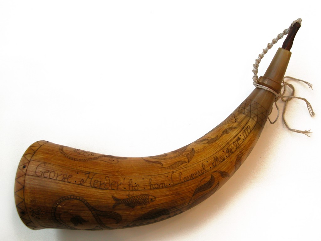 John Proud Dutchy HornThis horn is patterned after one in a rural New York Historical Society's collection. George Herder served in the Revolutionary War and Claverack is located in New York's Hudson River valley. The town's history goes back to the Dutch settlement period. The horn's decoration is a interesting combination of "Dutchy" themes ( hearts and flowers) and what I consider Native American themes (a turtle carapace? and wampum?). Then add the Christian theme of the fish! A lot of well thought out and displayed symbolism, along with an owners name, location and date. The original horn had a plain low domed base plug. I chose to add a chip carved design in the "Dutchy" tradition.Photo by Jan Riser